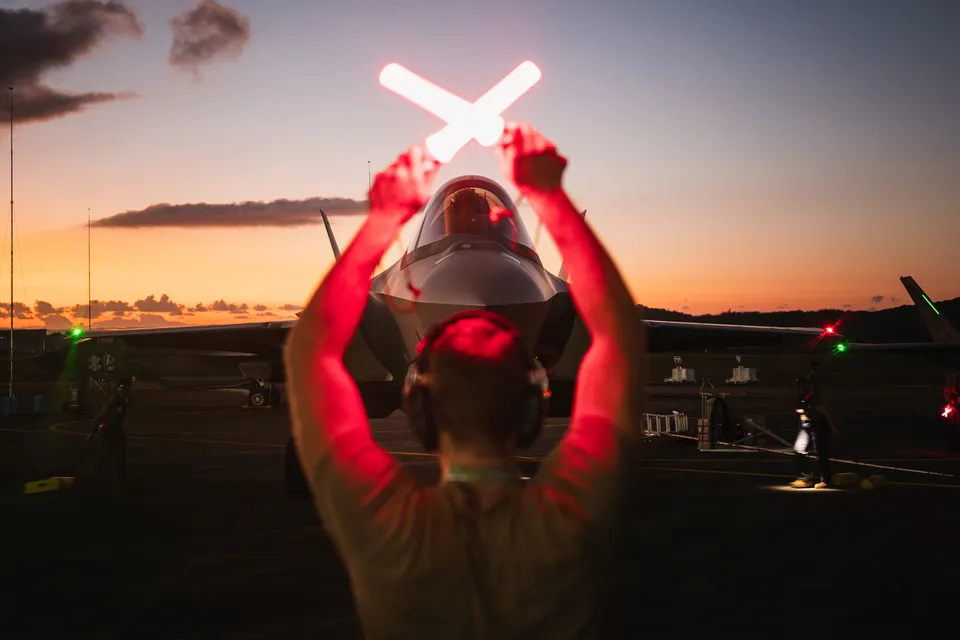 U.S. Air Force crew chief guiding an F-35A after Operation Absolute Resolve