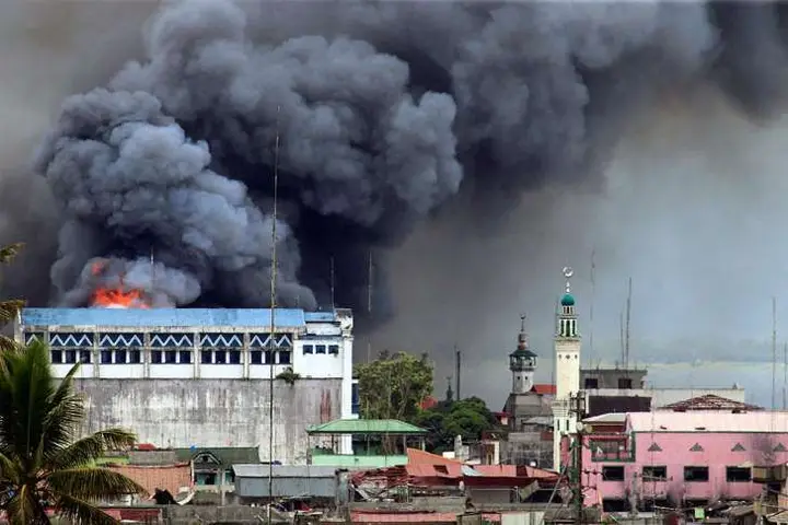A building burning in Marawi after an airstrike.