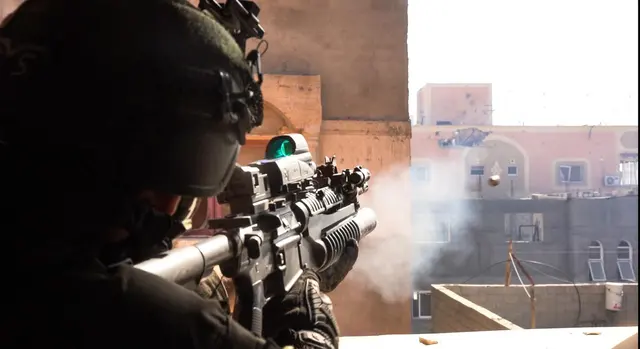 IDF soldier firing an M203 under-barrel grenade launcher