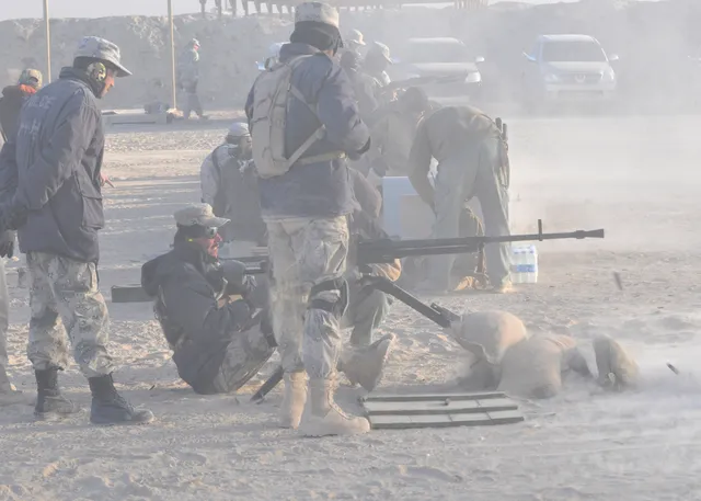 Afghan Border Police officer firing an NSV heavy machine gun during training at Spin Boldak
