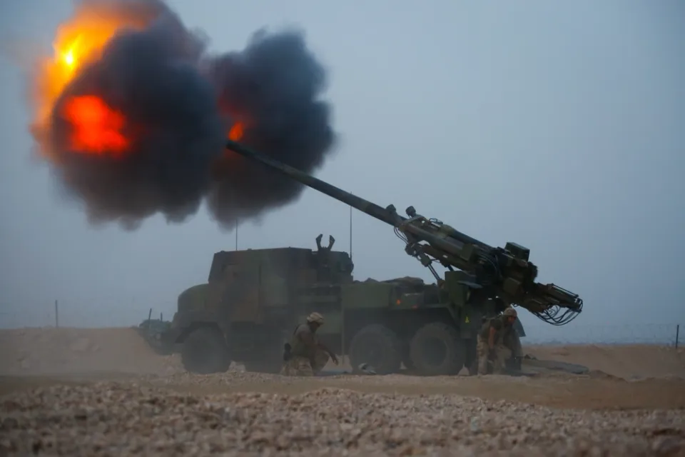 Coalition artillery crew conducts a fire mission from Firebase Saham during 2014 Operation Inherent Resolve.
