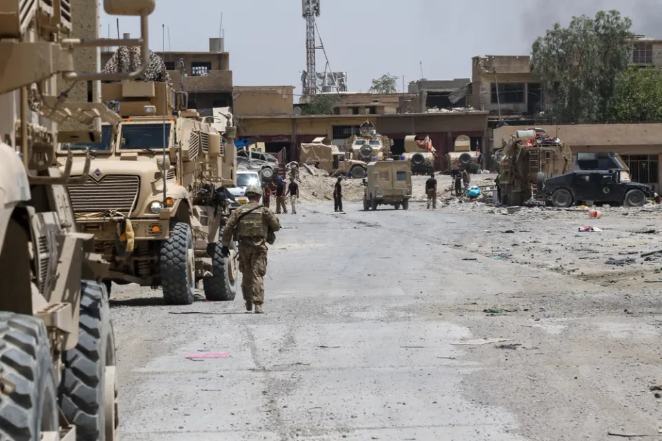 U.S. Army paratroopers meet Iraqi security force partners in a liberated Mosul neighborhood during 2014 Operation Inherent Resolve.