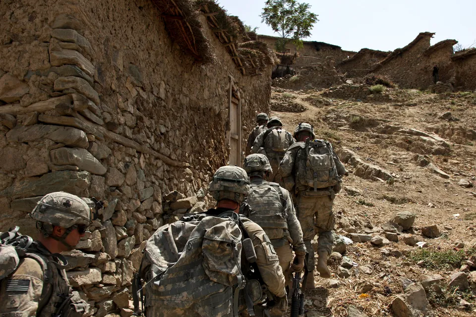 U.S. Army and Afghan National Army soldiers moving through mountainous terrain in Afghanistan